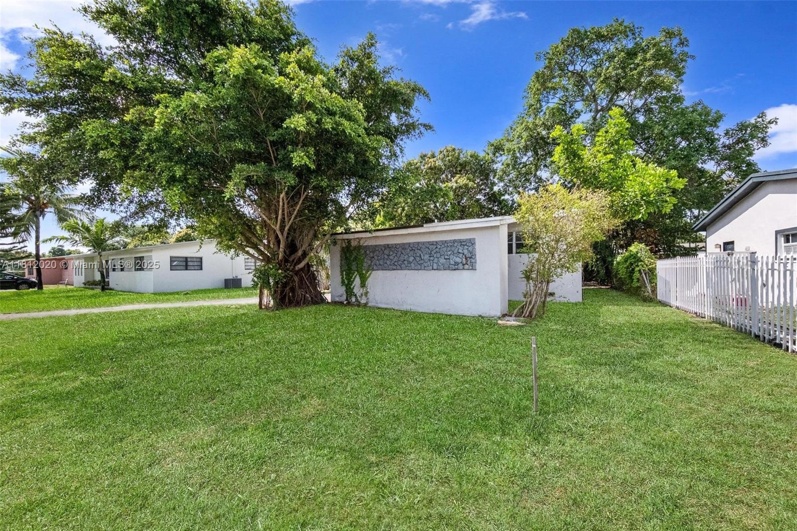 725 Northeast 178th Street Miami, FL 33162 - Photo 3 of 44 a view of a tree in front of a house