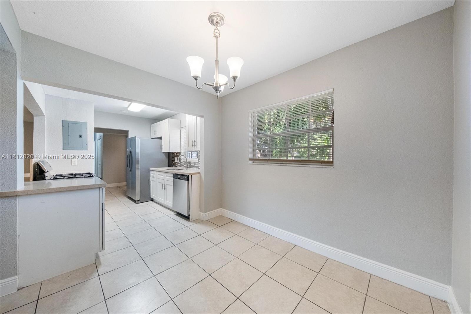 725 Northeast 178th Street Miami, FL 33162 - Photo 31 of 44 a large white kitchen with cabinets
