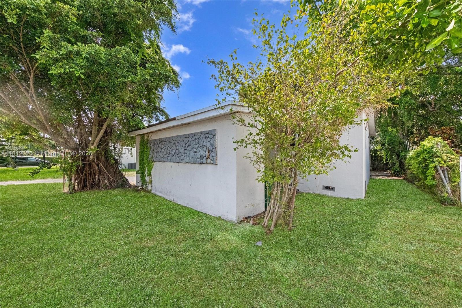 725 Northeast 178th Street Miami, FL 33162 - Photo 33 of 44 a view of a house with a tree and a tree