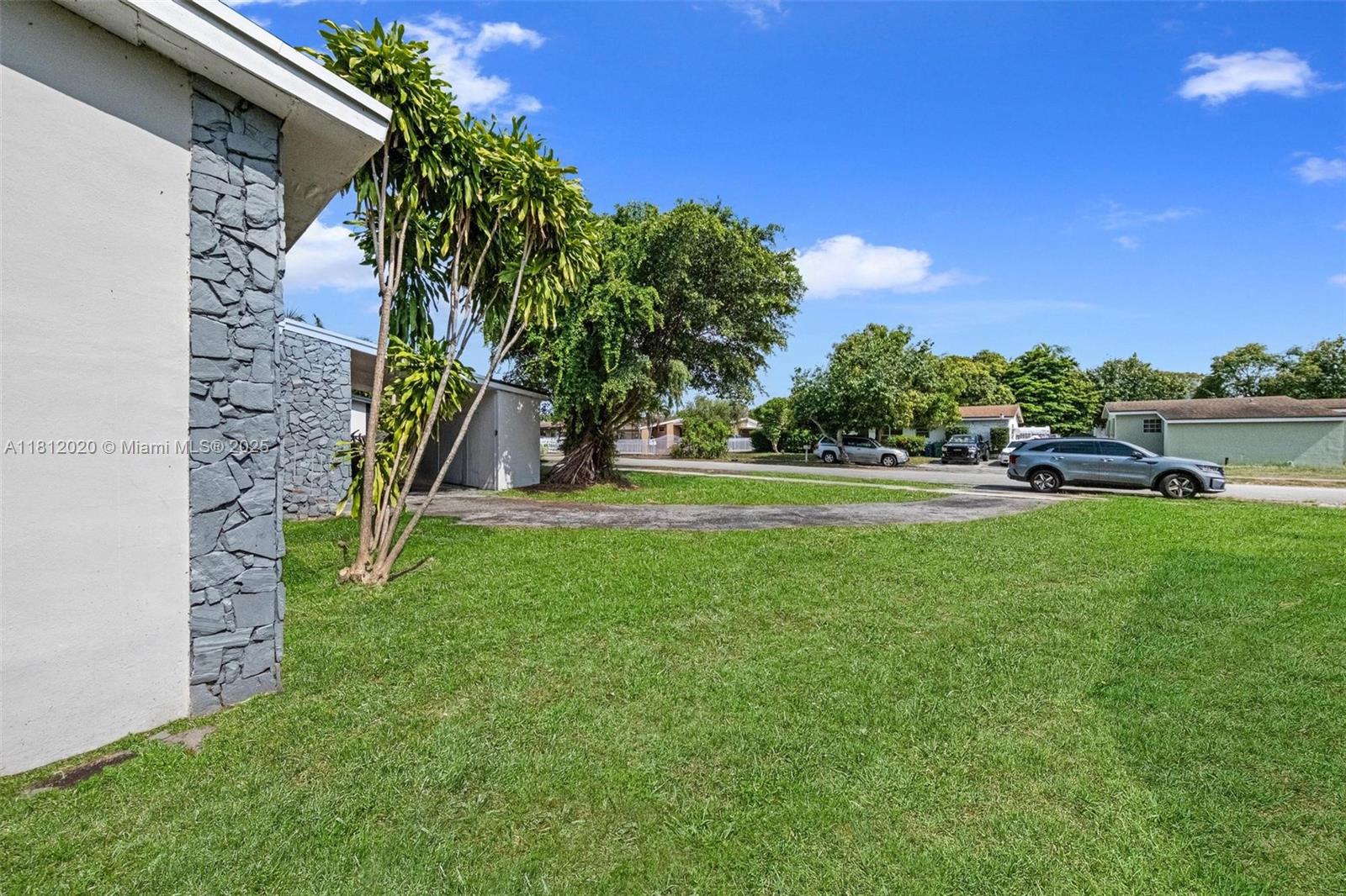 725 Northeast 178th Street Miami, FL 33162 - Photo 36 of 44 a view of a park with large trees