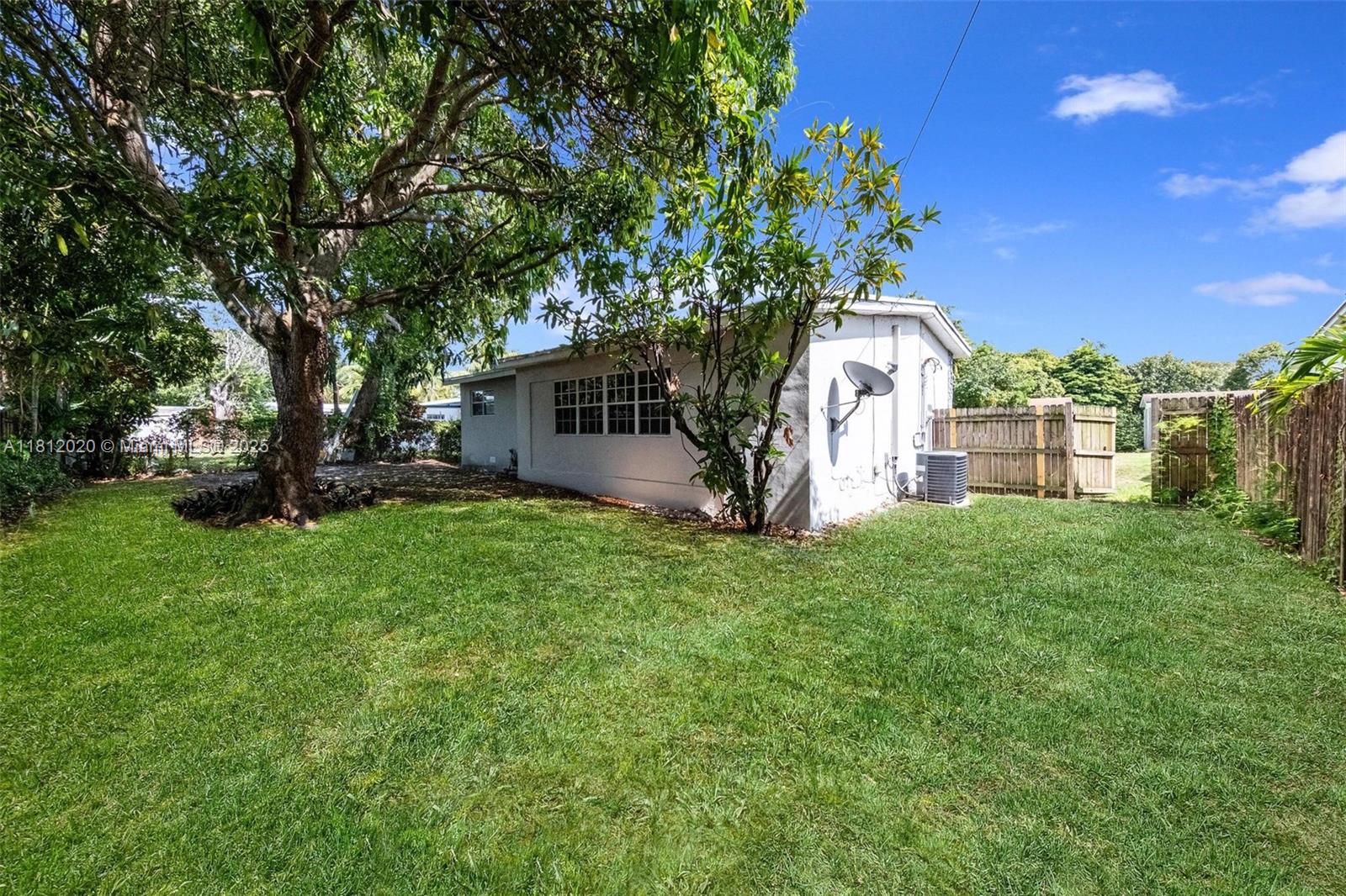 725 Northeast 178th Street Miami, FL 33162 - Photo 42 of 44 a view of a backyard with a garden and entertaining space