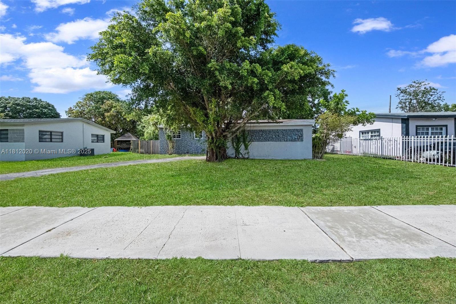725 Northeast 178th Street Miami, FL 33162 - Photo 43 of 44 a view of a yard with palm trees