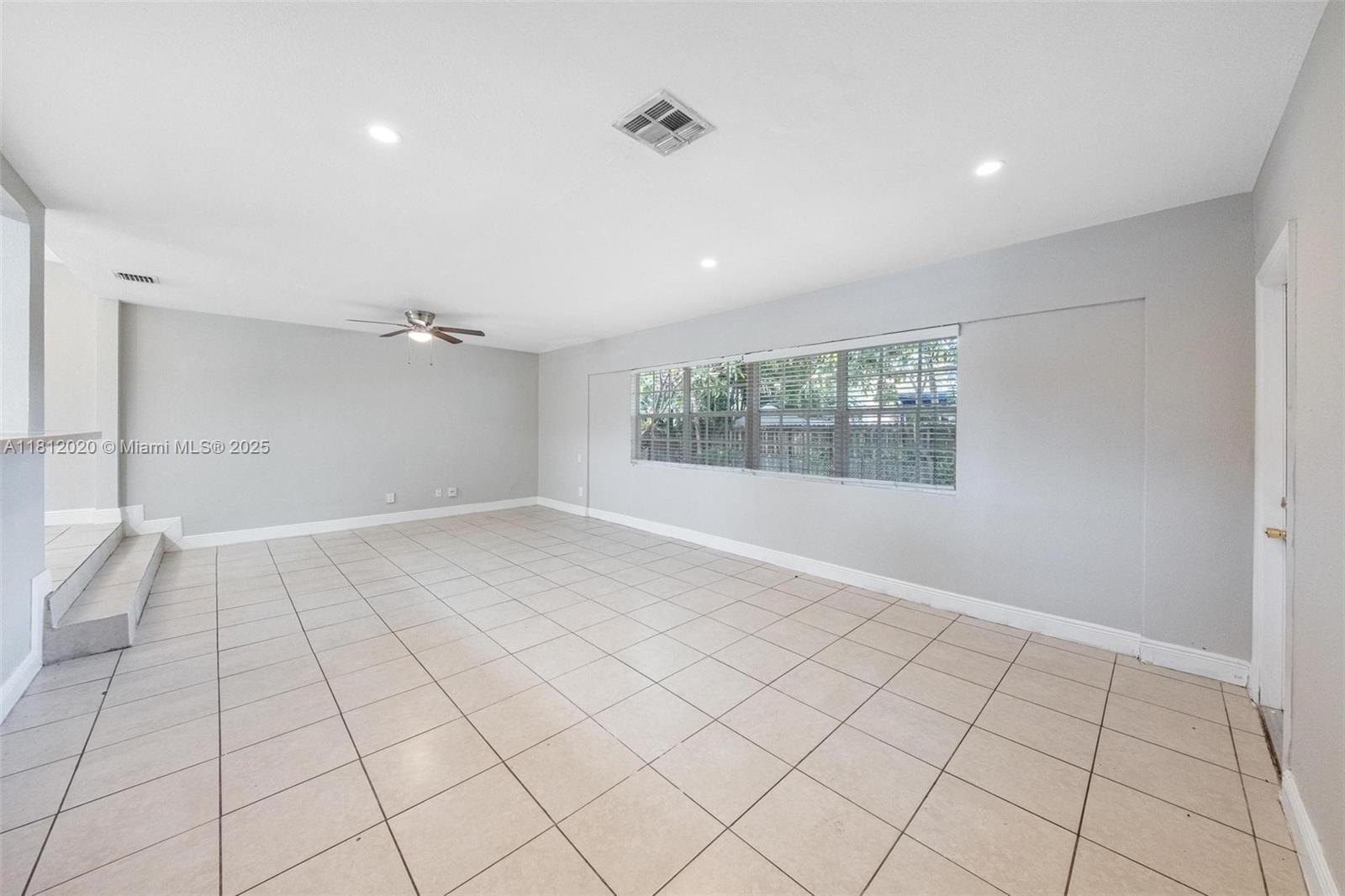 725 Northeast 178th Street Miami, FL 33162 - Photo 7 of 44 a view of an empty room and window