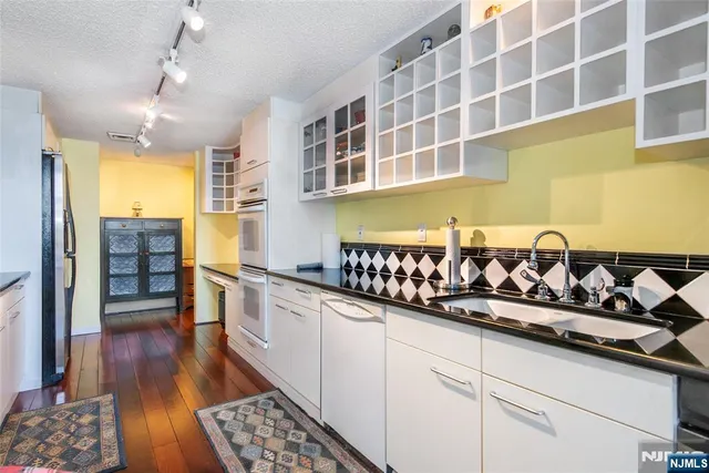 a bathroom with a sink mirror vanity and toilet