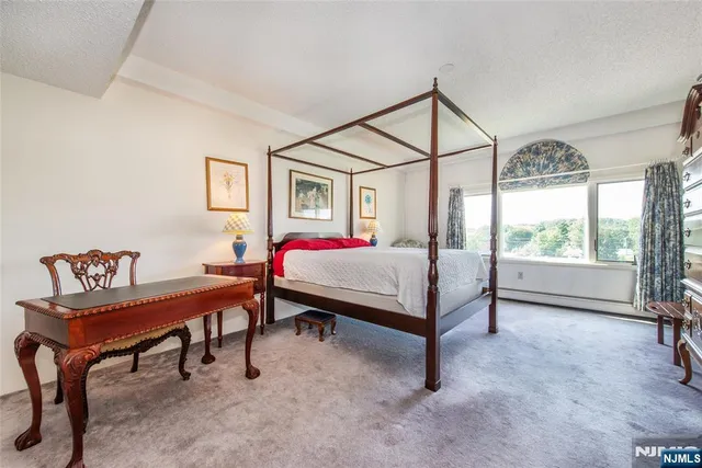 a bed room with a bed and a chair