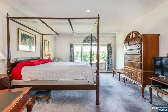 a spacious bathroom with a tub sink and mirror