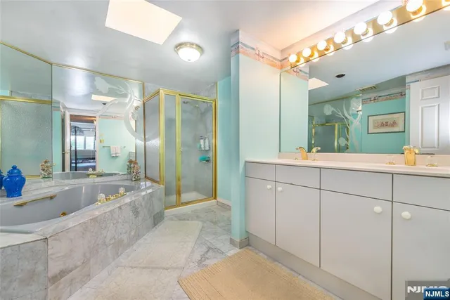 a bedroom with a bed and a large mirror