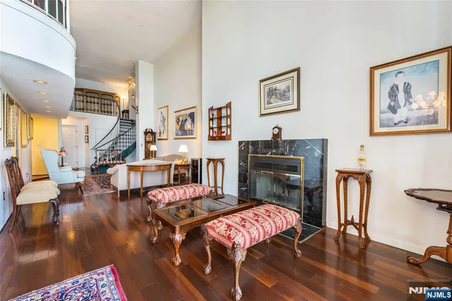 a view of a dining room with furniture a chandelier and wooden floor