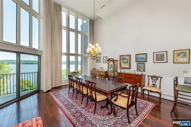 a dining room with furniture a rug and wooden floor