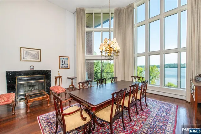 a dining room with furniture a rug and a chandelier