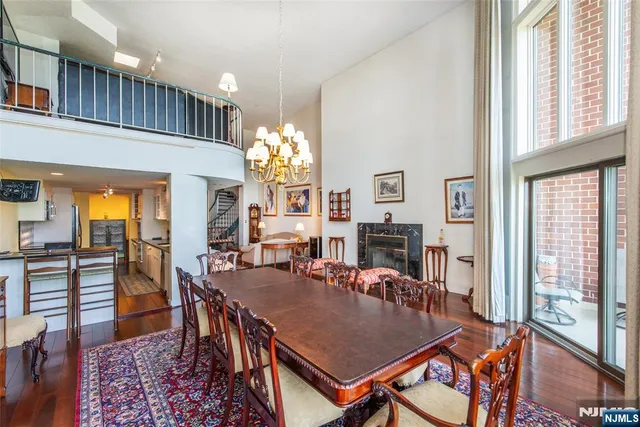 a view of a dining room with furniture and chandelier