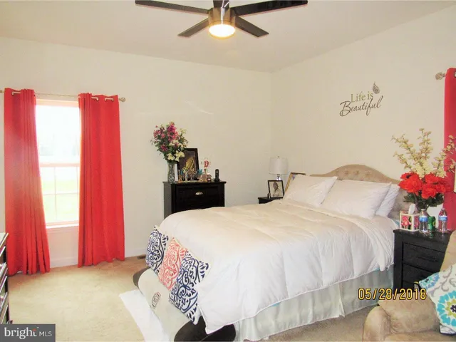a bedroom with a bed and a potted plant