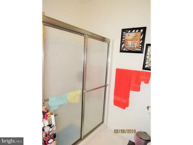 a bathroom with a shower and a painting on the wall