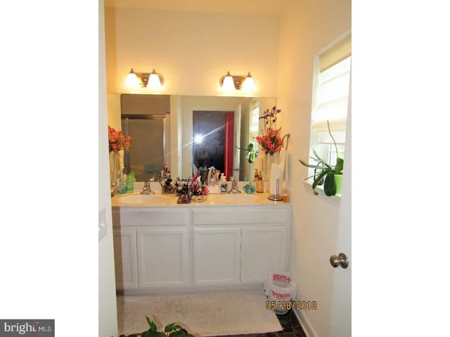 a bathroom with a sink vanity mirror and toilet