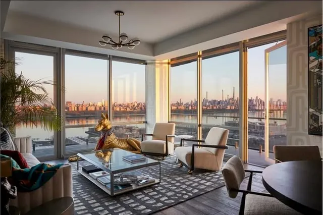 a living room with furniture and a floor to ceiling window