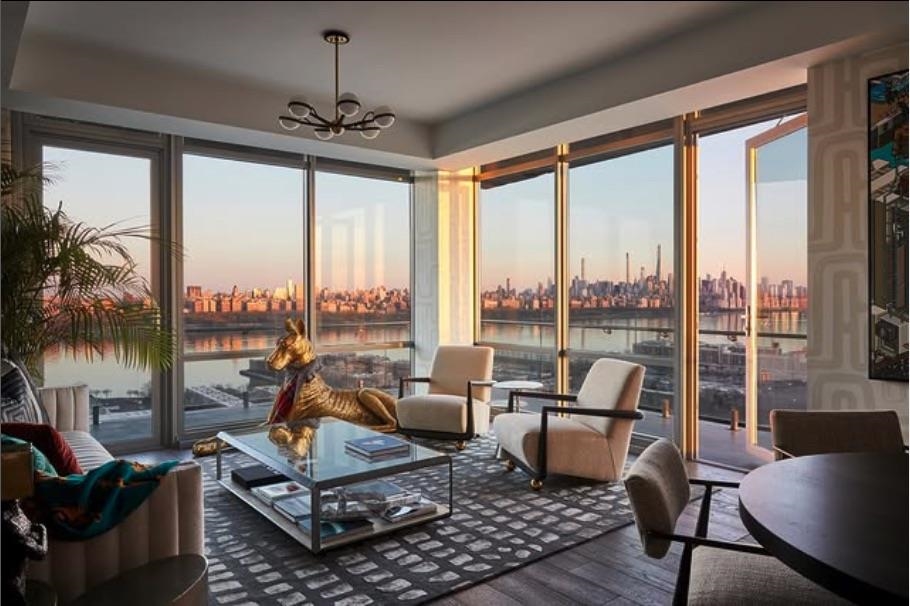 a living room with furniture and a floor to ceiling window