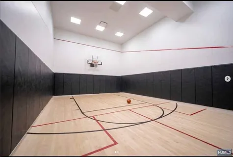 a view of a refrigerator in kitchen and wooden cabinets