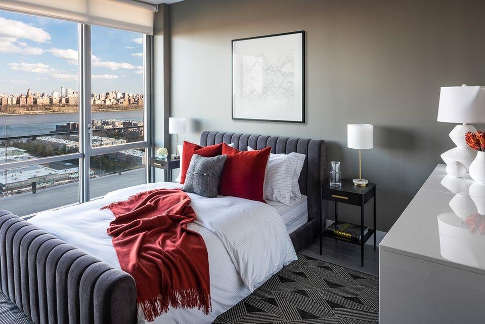 320 Adolphus Avenue, Unit 815 Cliffside Park, NJ 07010 - Photo 3 of 25 a bedroom with a bed and lamp with window