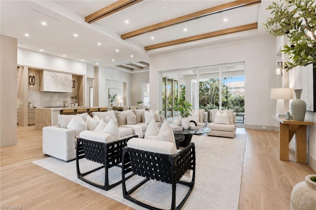 4851 Crayton Road Naples, FL 34103 - Photo 5 of 33 Expansive open-concept living space featuring wood-finish flooring and exposed ceiling beams