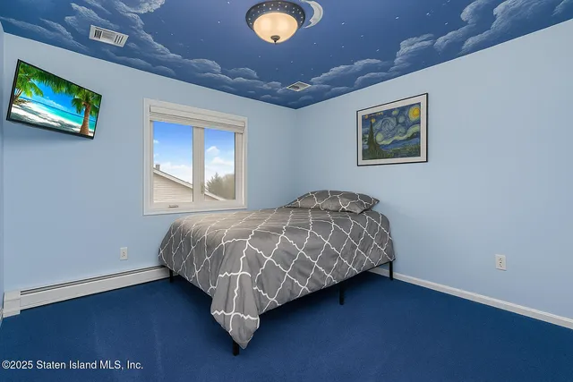 a bedroom with a bed and a dresser