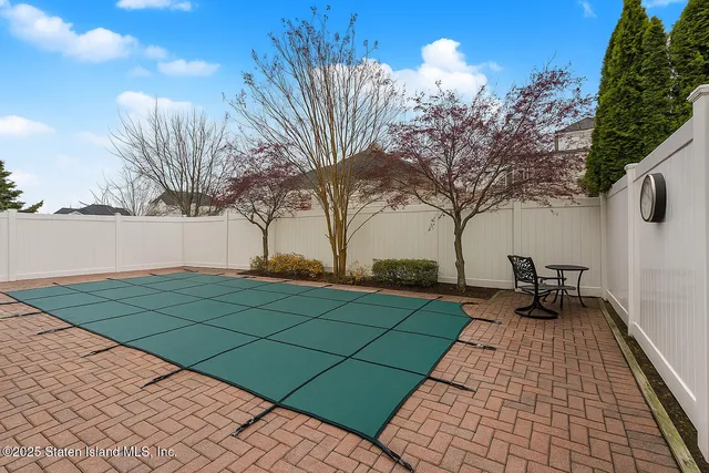 a view of a house with backyard and deck