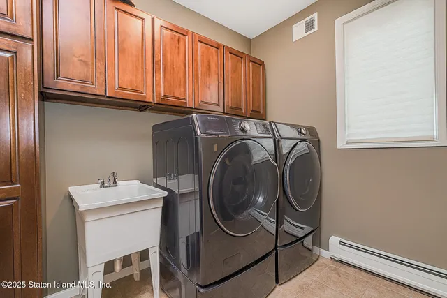 a utility room with sink dryer and washer