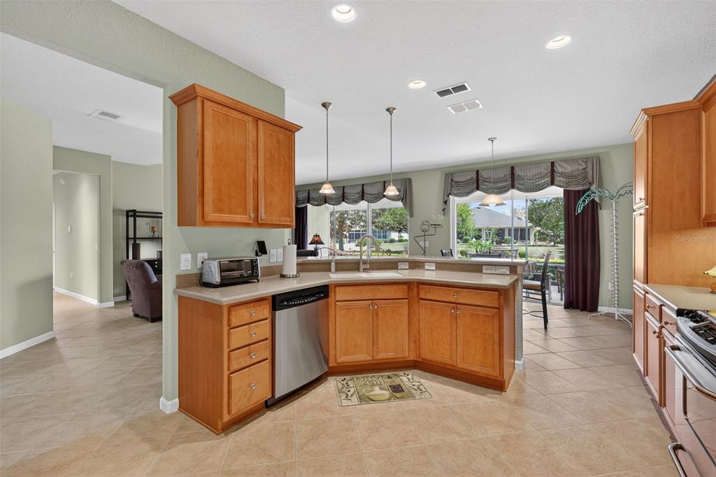 7271 Southwest 95th Court Ocala, FL 34481 - Photo 11 of 39 a kitchen with stainless steel appliances granite countertop a stove a sink and a refrigerator