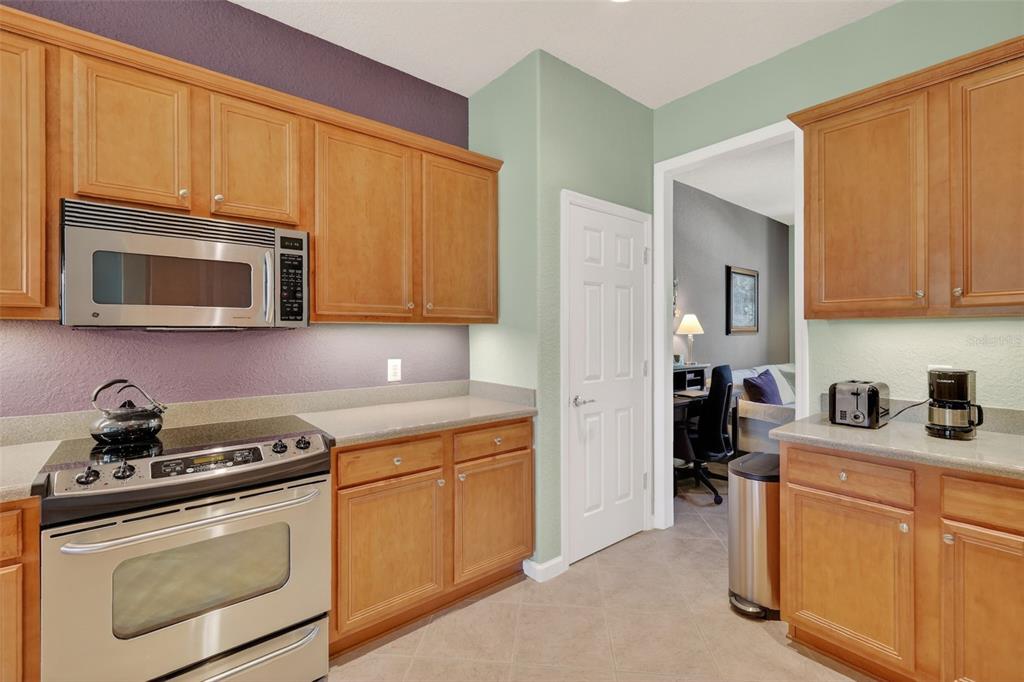 7271 Southwest 95th Court Ocala, FL 34481 - Photo 12 of 39 a kitchen with stainless steel appliances granite countertop a sink stove and microwave