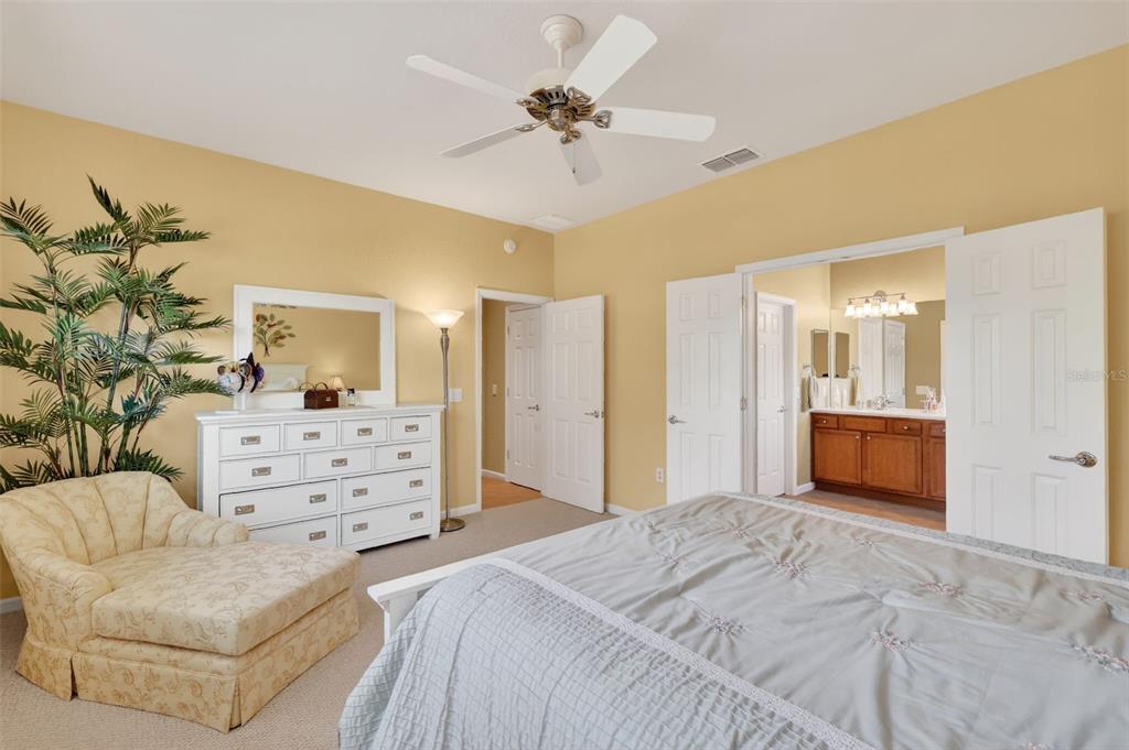 7271 Southwest 95th Court Ocala, FL 34481 - Photo 18 of 39 a bedroom with a bed and ceiling fan