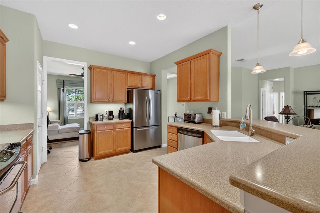 7271 Southwest 95th Court Ocala, FL 34481 - Photo 10 of 39 a kitchen with stainless steel appliances granite countertop a sink refrigerator and cabinets