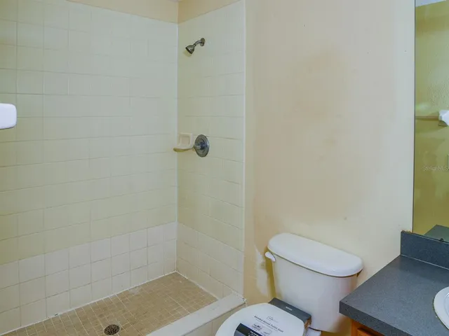 a white toilet sitting next to a bath tub