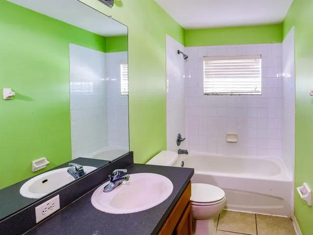 a bathroom with a sink a toilet and bathtub