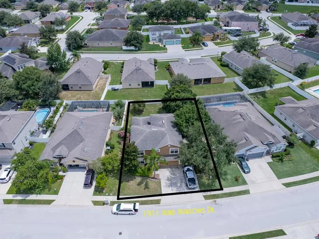 an aerial view of multiple houses with yard