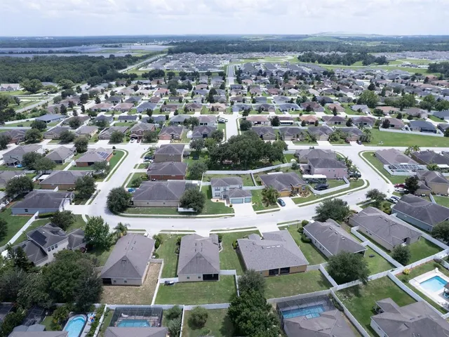 an aerial view of residential houses with outdoor space