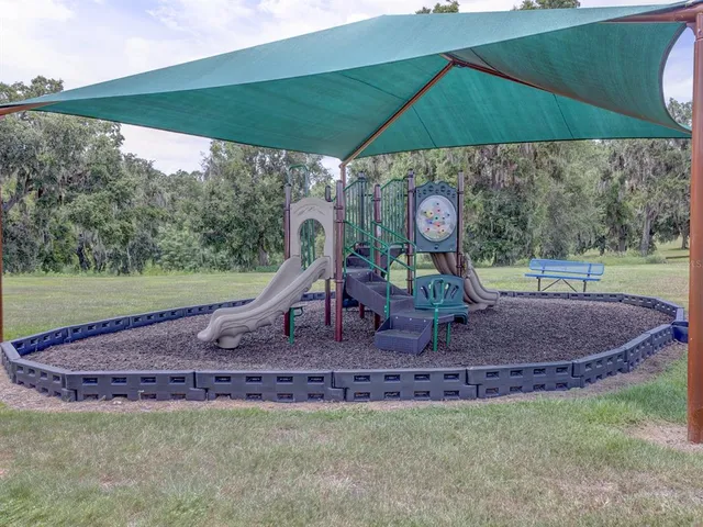 a table and chairs sitting under an umbrella