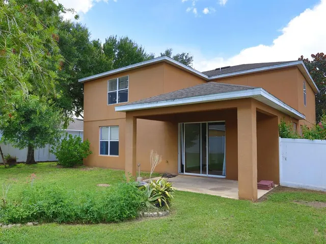 a view of a house with yard and a garden