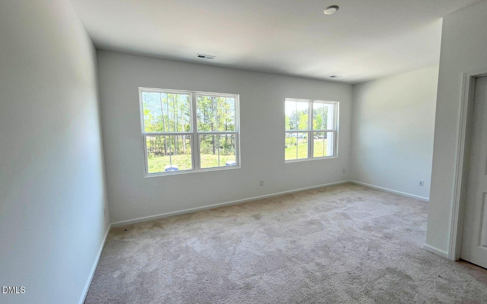 2430 Whitewing Lane Wendell, NC 27591 - Photo 11 of 31 an empty room with windows