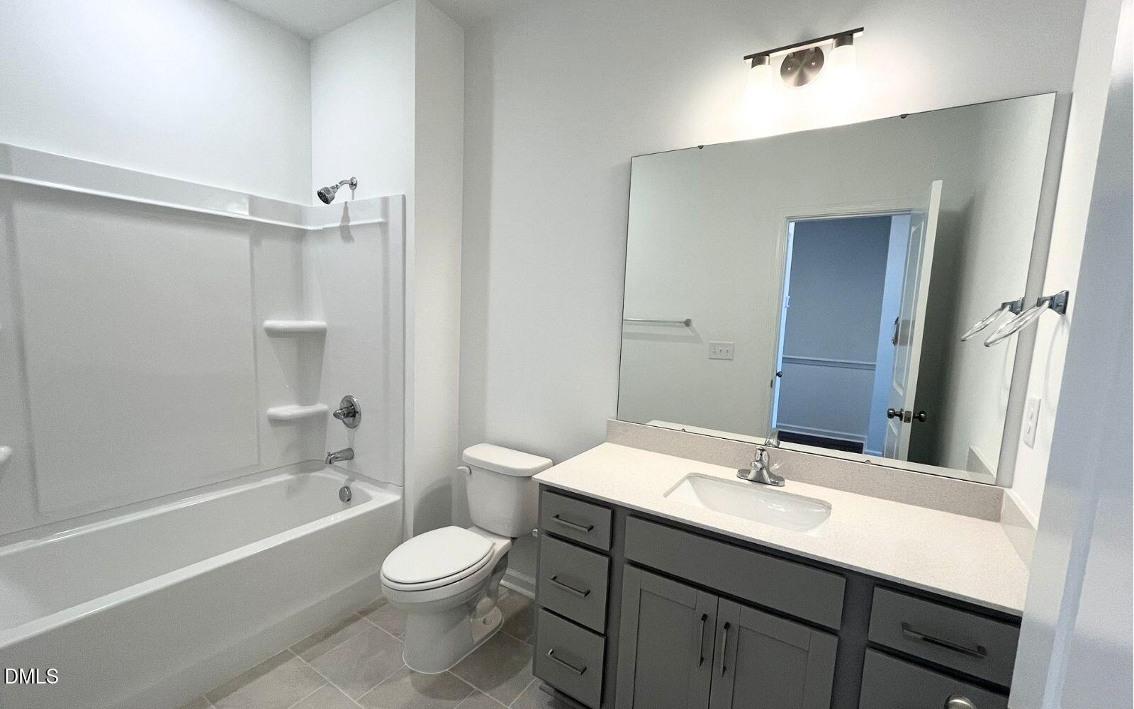 2430 Whitewing Lane Wendell, NC 27591 - Photo 16 of 31 a bathroom with a sink a toilet a mirror and shower