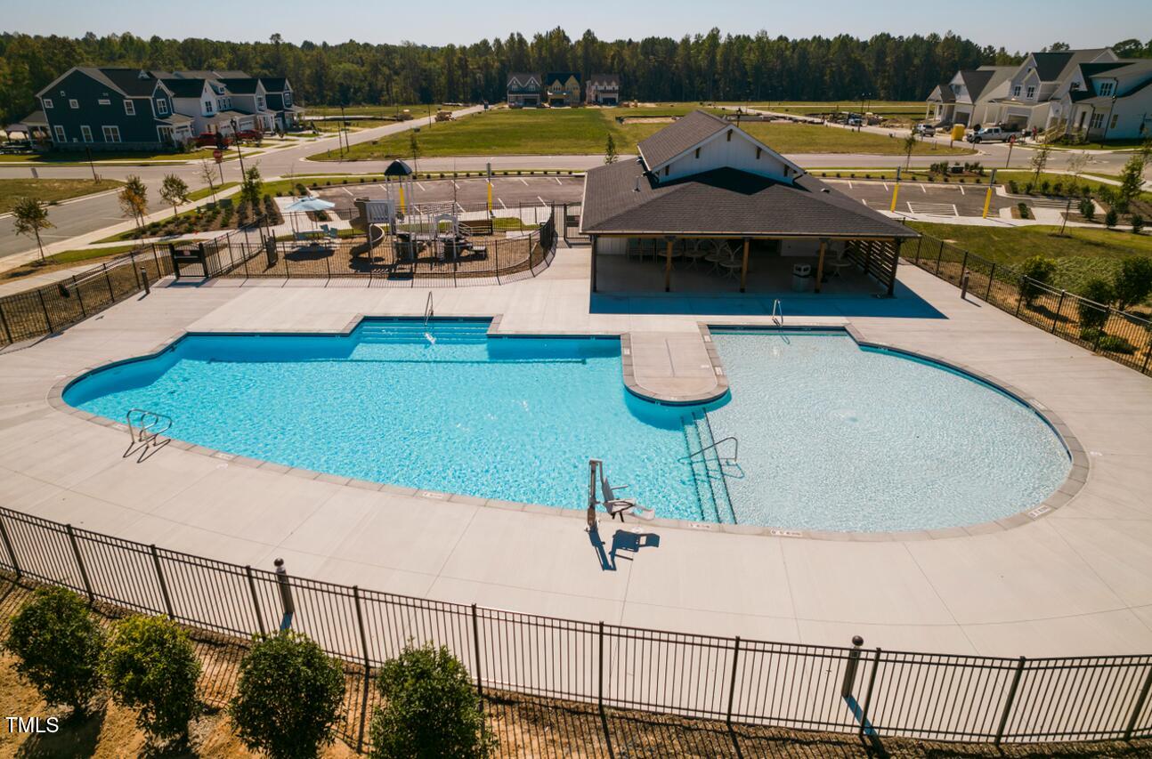 2430 Whitewing Lane Wendell, NC 27591 - Photo 17 of 31 a view of a swimming pool with a lounge chair
