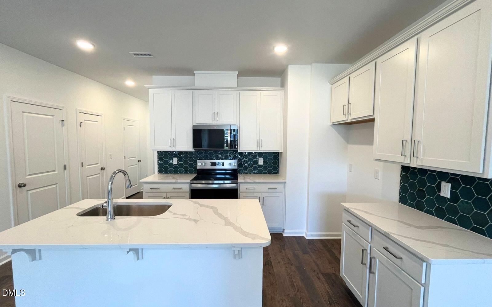 2430 Whitewing Lane Wendell, NC 27591 - Photo 6 of 31 a kitchen with sink a microwave and cabinets