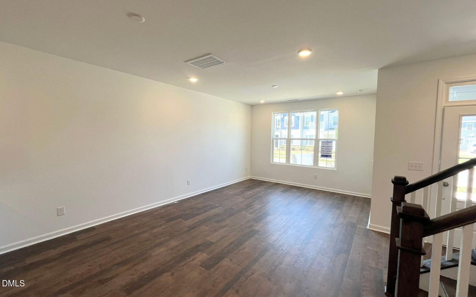 2430 Whitewing Lane Wendell, NC 27591 - Photo 7 of 31 wooden floor in an empty room with a window
