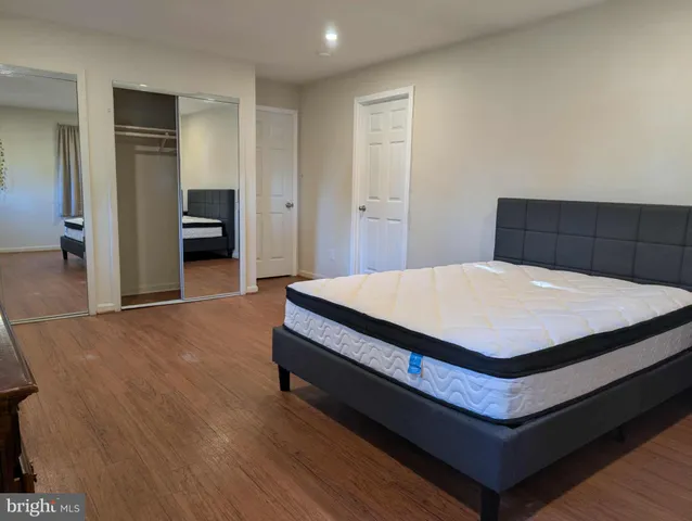 a bed sitting in a spacious bedroom next to a window