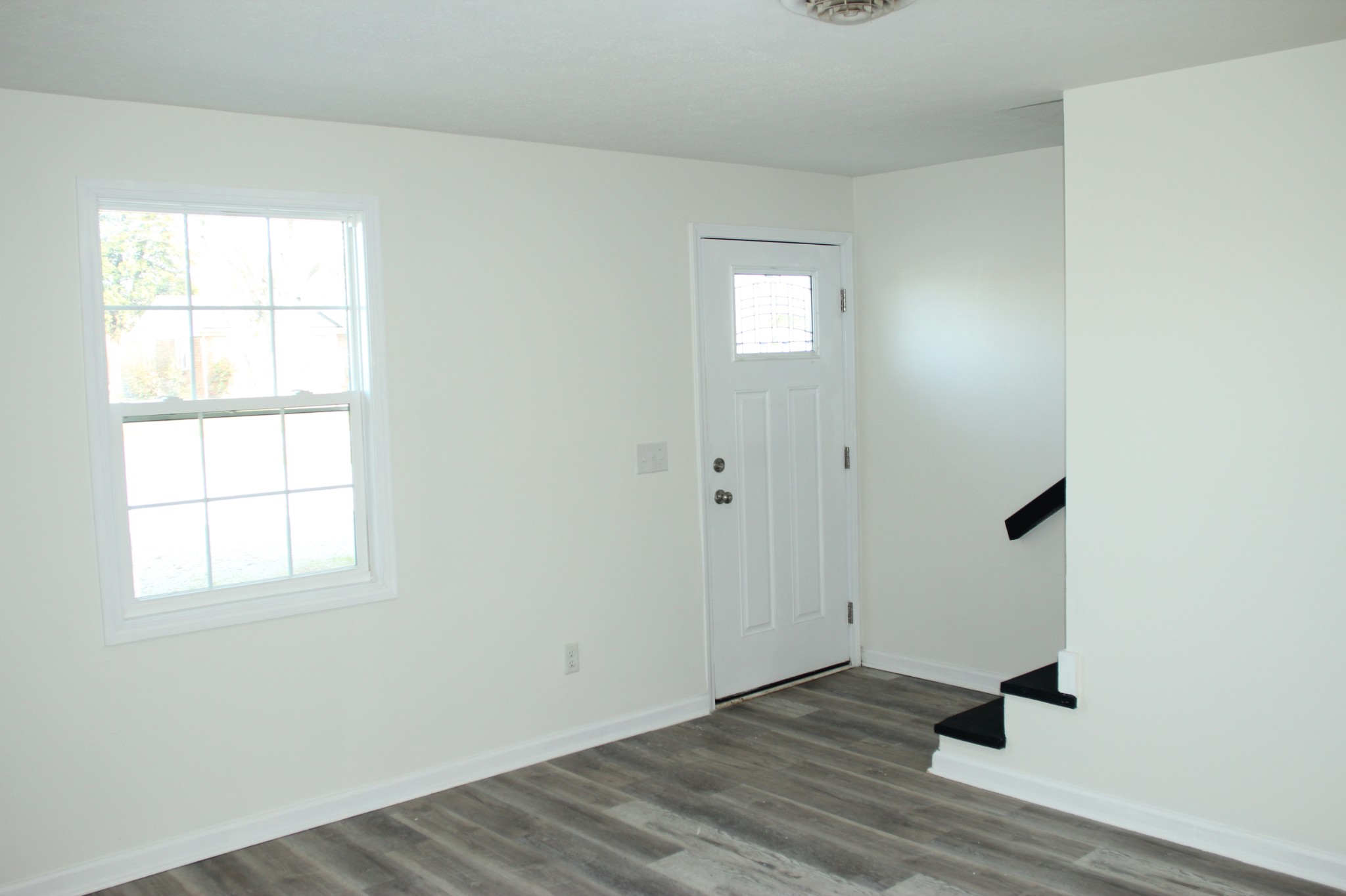 517 Bybee Branch Road, Unit 43 McMinnville, TN 37110 - Photo 2 of 14 an empty room with wooden floor cabinet and windows