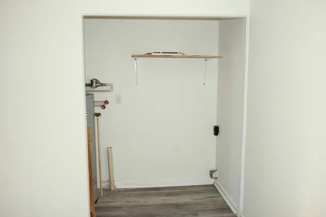 a view of a room with wooden floor