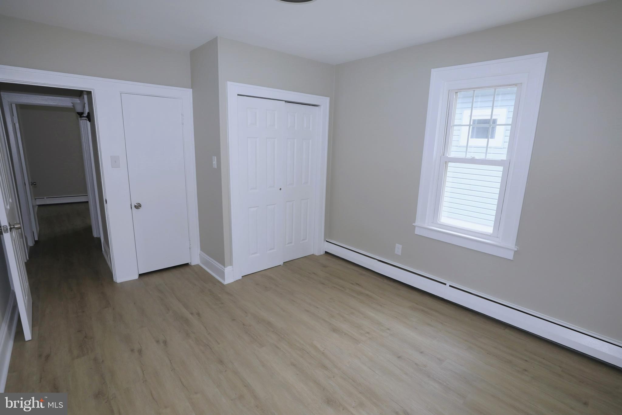 36 Emanuel Street Hamilton, NJ 08610 - Photo 11 of 26 an empty room with wooden floor and windows