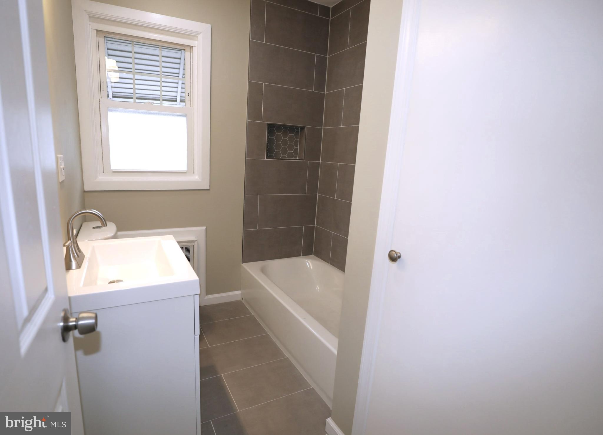 36 Emanuel Street Hamilton, NJ 08610 - Photo 13 of 26 a bathroom with a bathtub sink and window