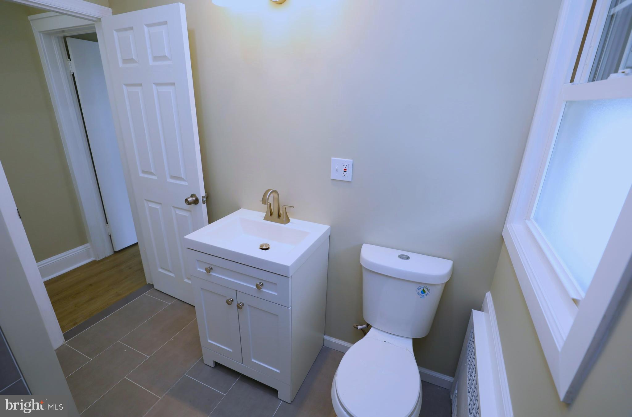 36 Emanuel Street Hamilton, NJ 08610 - Photo 15 of 26 a bathroom with a toilet sink and mirror