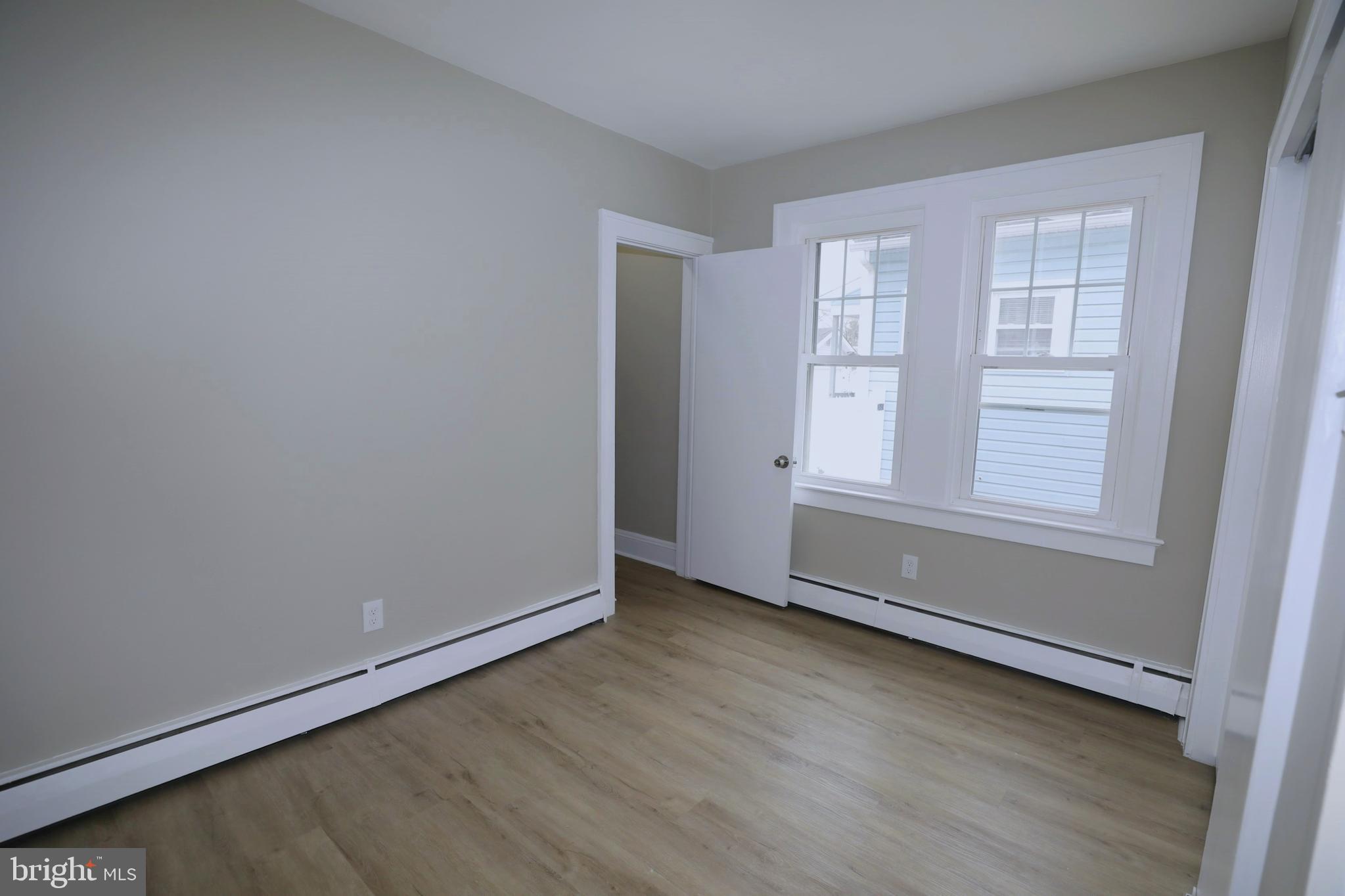 36 Emanuel Street Hamilton, NJ 08610 - Photo 16 of 26 an empty room with wooden floor and windows