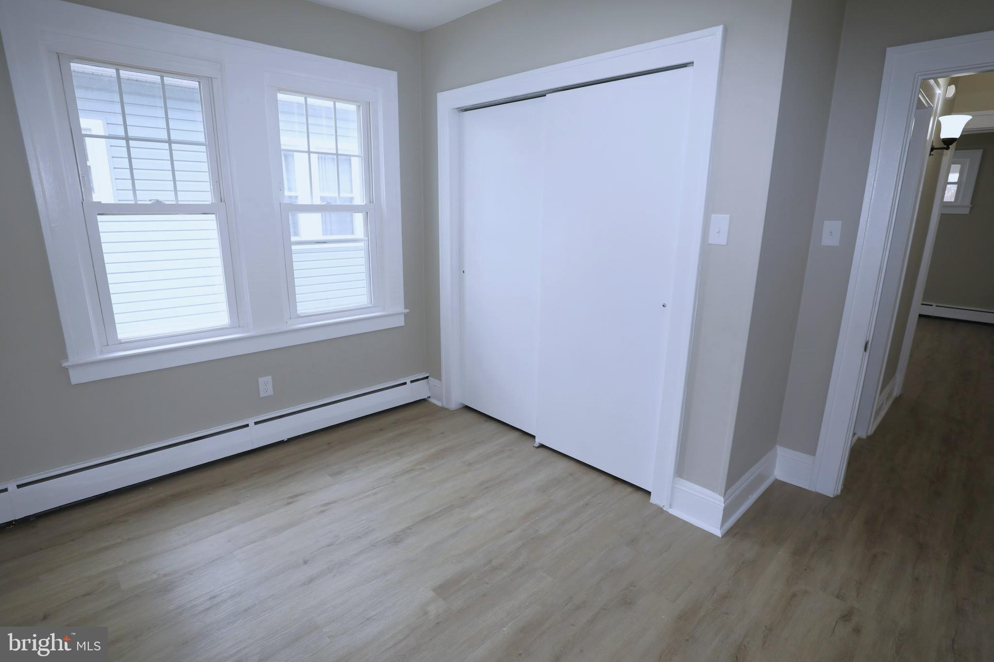 36 Emanuel Street Hamilton, NJ 08610 - Photo 17 of 26 an empty room with wooden floor and windows