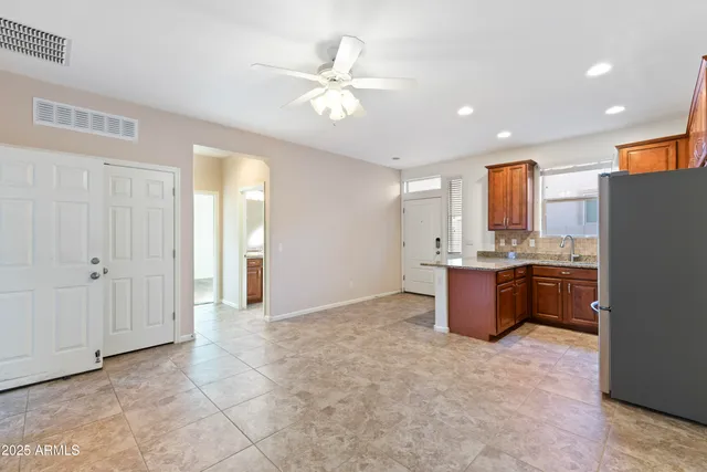 a view of kitchen with refrigerator and window